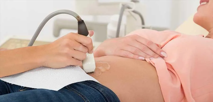 A woman is having a pelvic ultrasound scan.